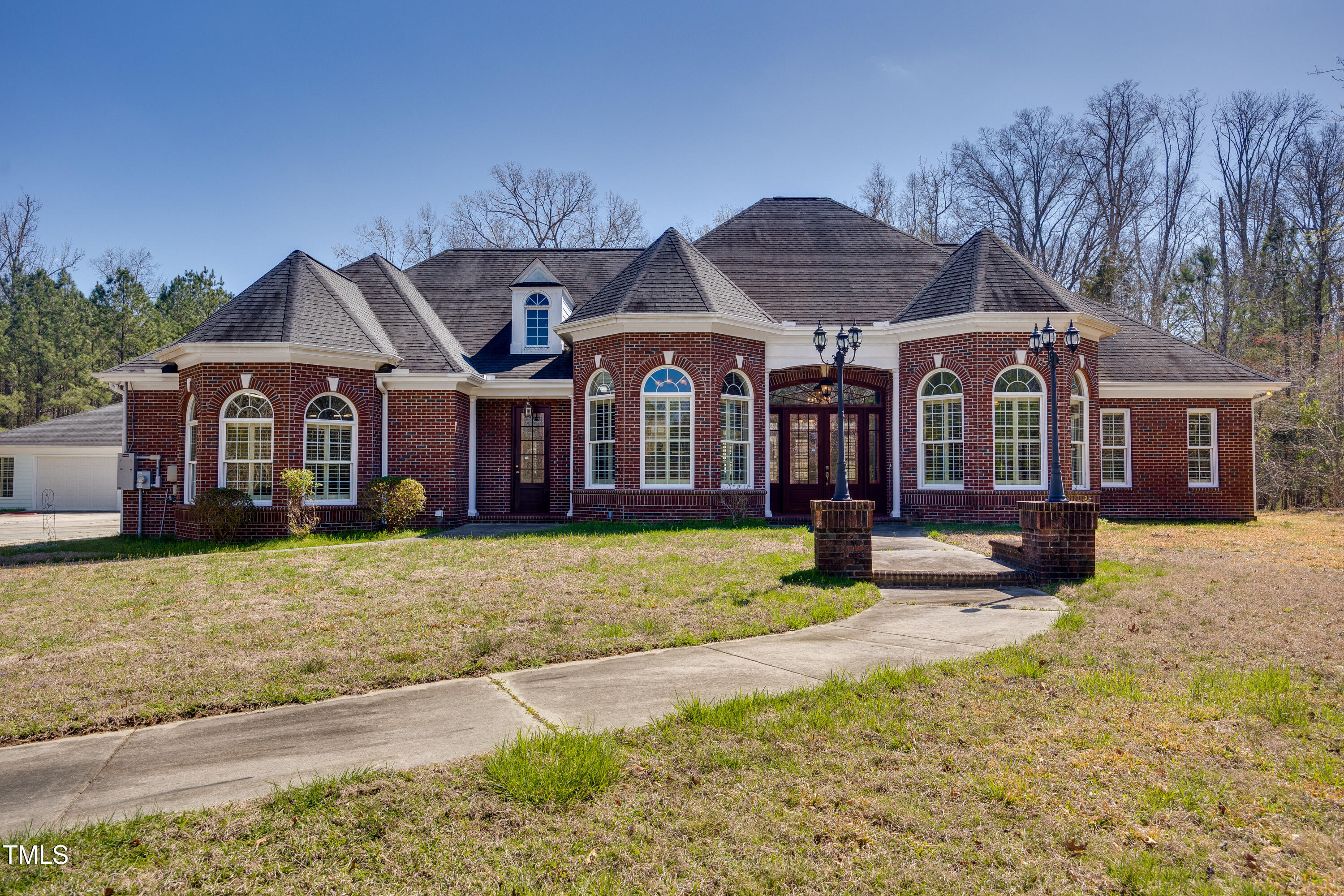 a front view of a house with yard and seating space