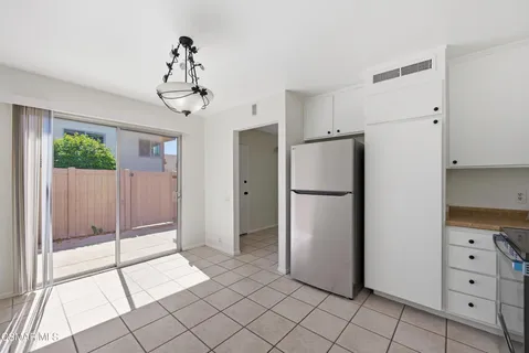 a view of a kitchen with a refrigerator and cabinets
