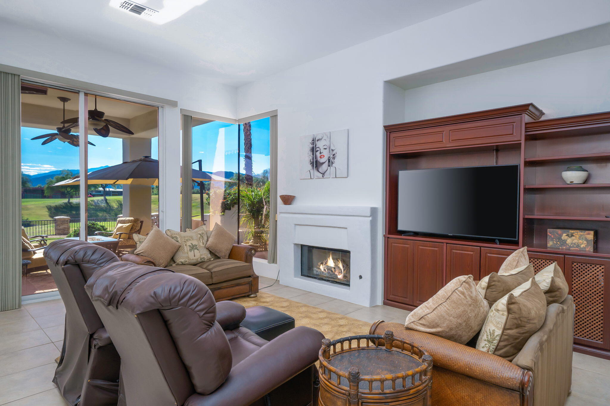 290 Loch Lomond Road Rancho Mirage, CA 92270 - Photo 15 of 50 a living room with furniture a fireplace and a flat screen tv
