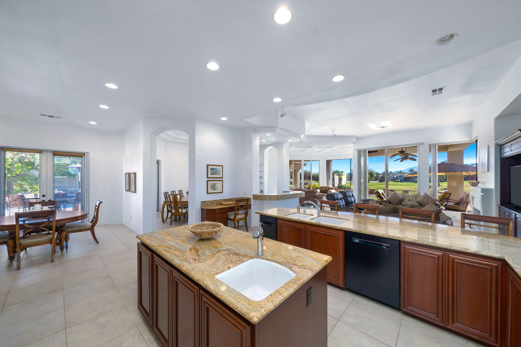 290 Loch Lomond Road Rancho Mirage, CA 92270 - Photo 17 of 50 a large kitchen with kitchen island a sink a stove a dining table and chairs