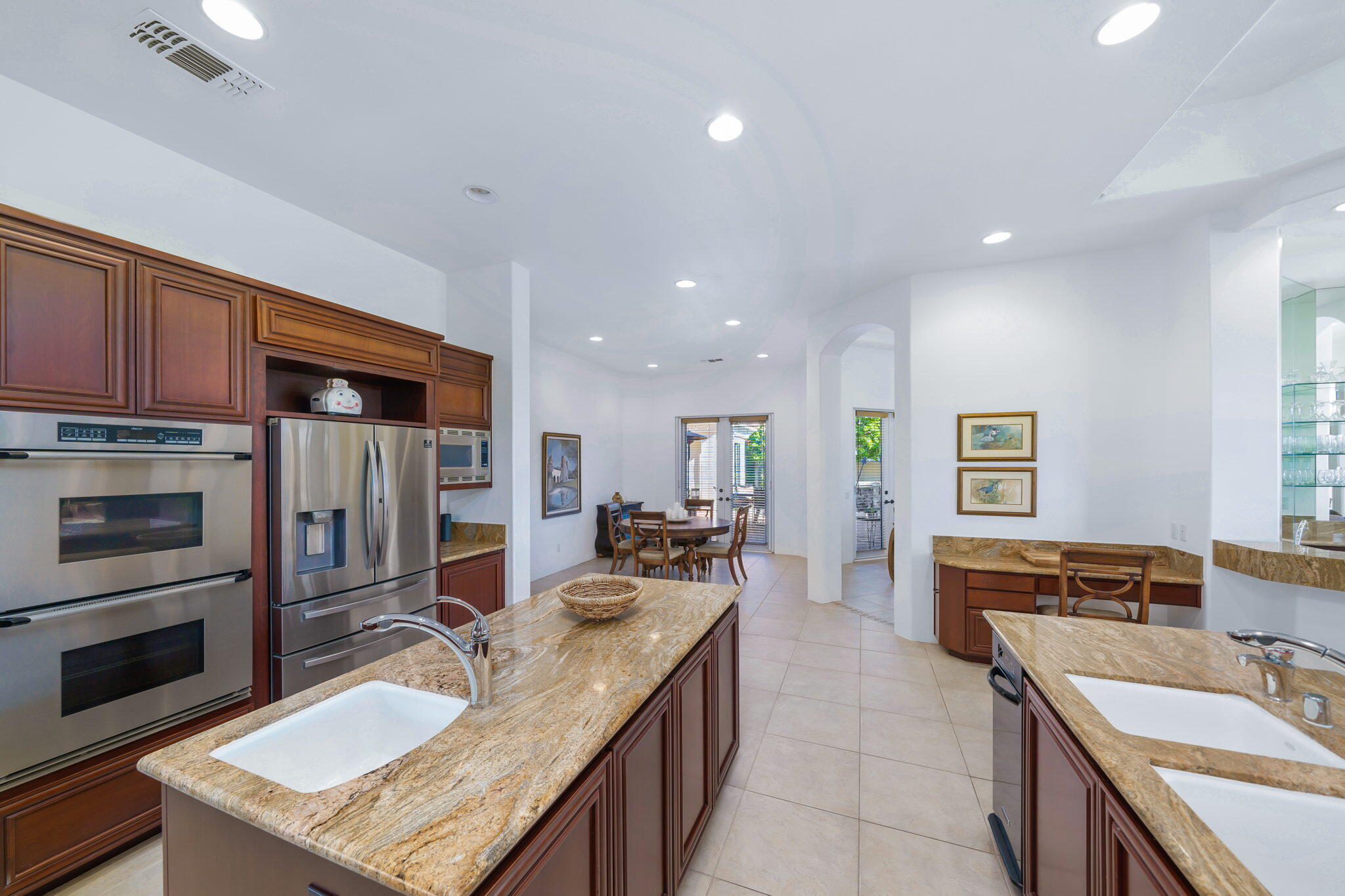 290 Loch Lomond Road Rancho Mirage, CA 92270 - Photo 19 of 50 a kitchen with stainless steel appliances granite countertop a sink stove and refrigerator