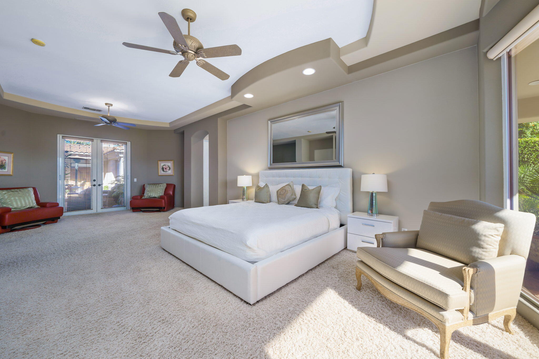 290 Loch Lomond Road Rancho Mirage, CA 92270 - Photo 25 of 50 a spacious bedroom with a bed a couch and a ceiling fan
