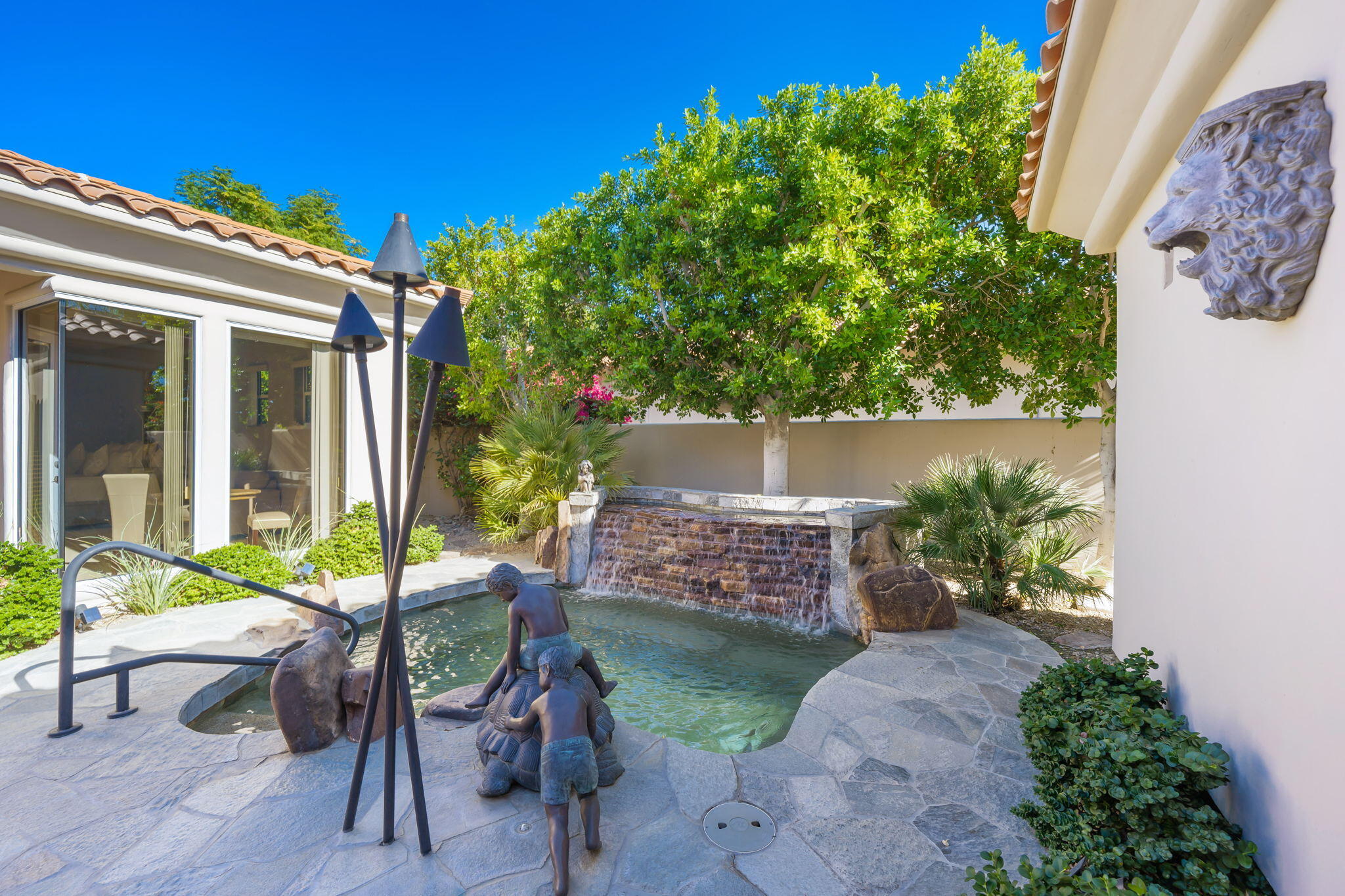 290 Loch Lomond Road Rancho Mirage, CA 92270 - Photo 4 of 50 a view of a patio with table and chairs and potted plants