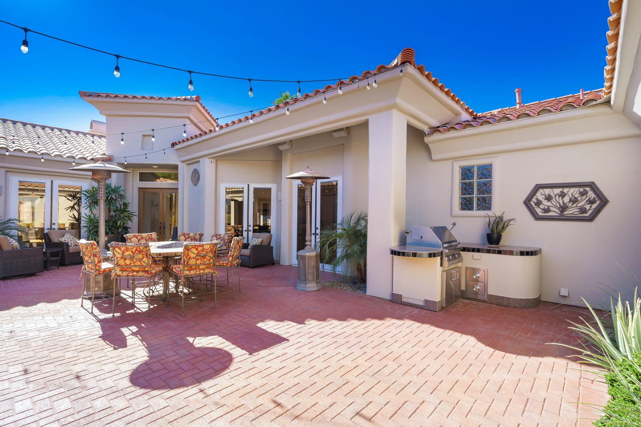 290 Loch Lomond Road Rancho Mirage, CA 92270 - Photo 38 of 50 a view of a patio with couches table and chairs and potted plants