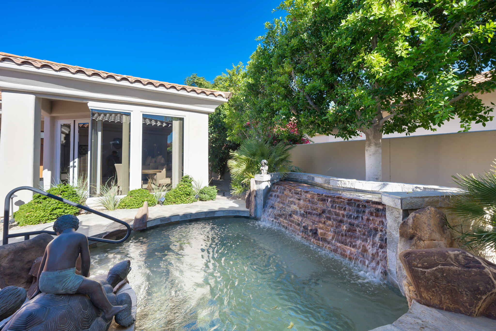 290 Loch Lomond Road Rancho Mirage, CA 92270 - Photo 40 of 50 a view of a patio with couches table and chairs and potted plants