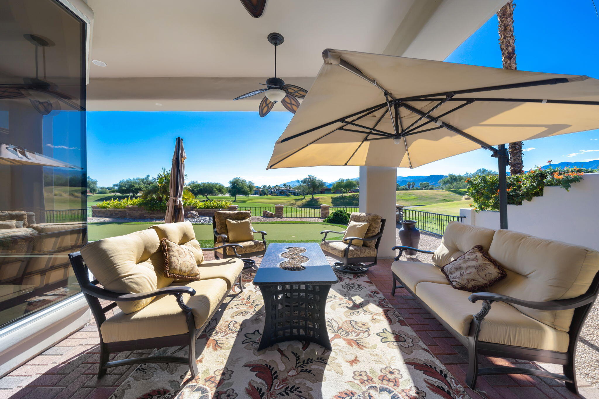 290 Loch Lomond Road Rancho Mirage, CA 92270 - Photo 42 of 50 a view of a patio with a table chairs and a umbrella