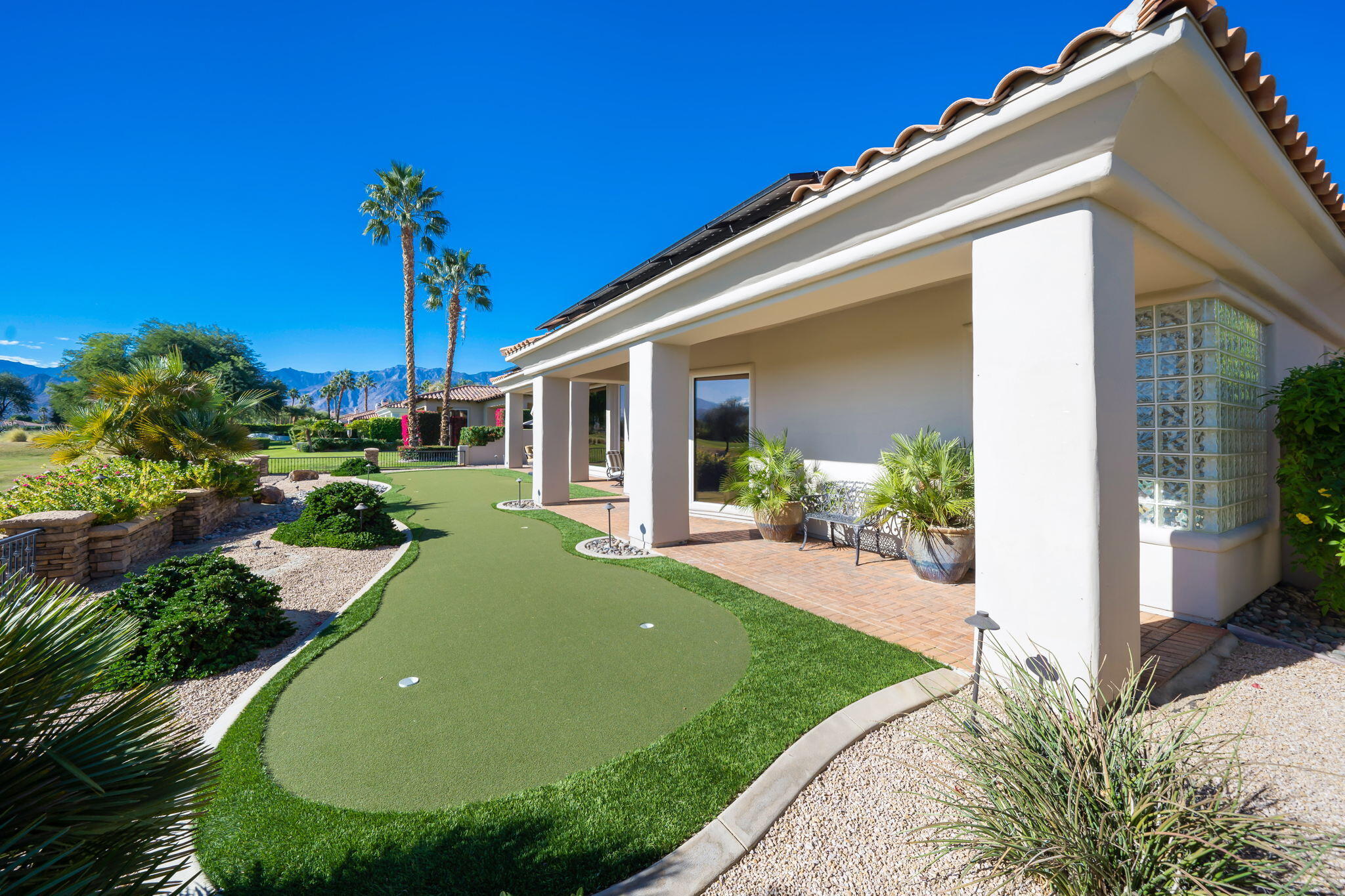 290 Loch Lomond Road Rancho Mirage, CA 92270 - Photo 46 of 50 a view of a house with a backyard and porch
