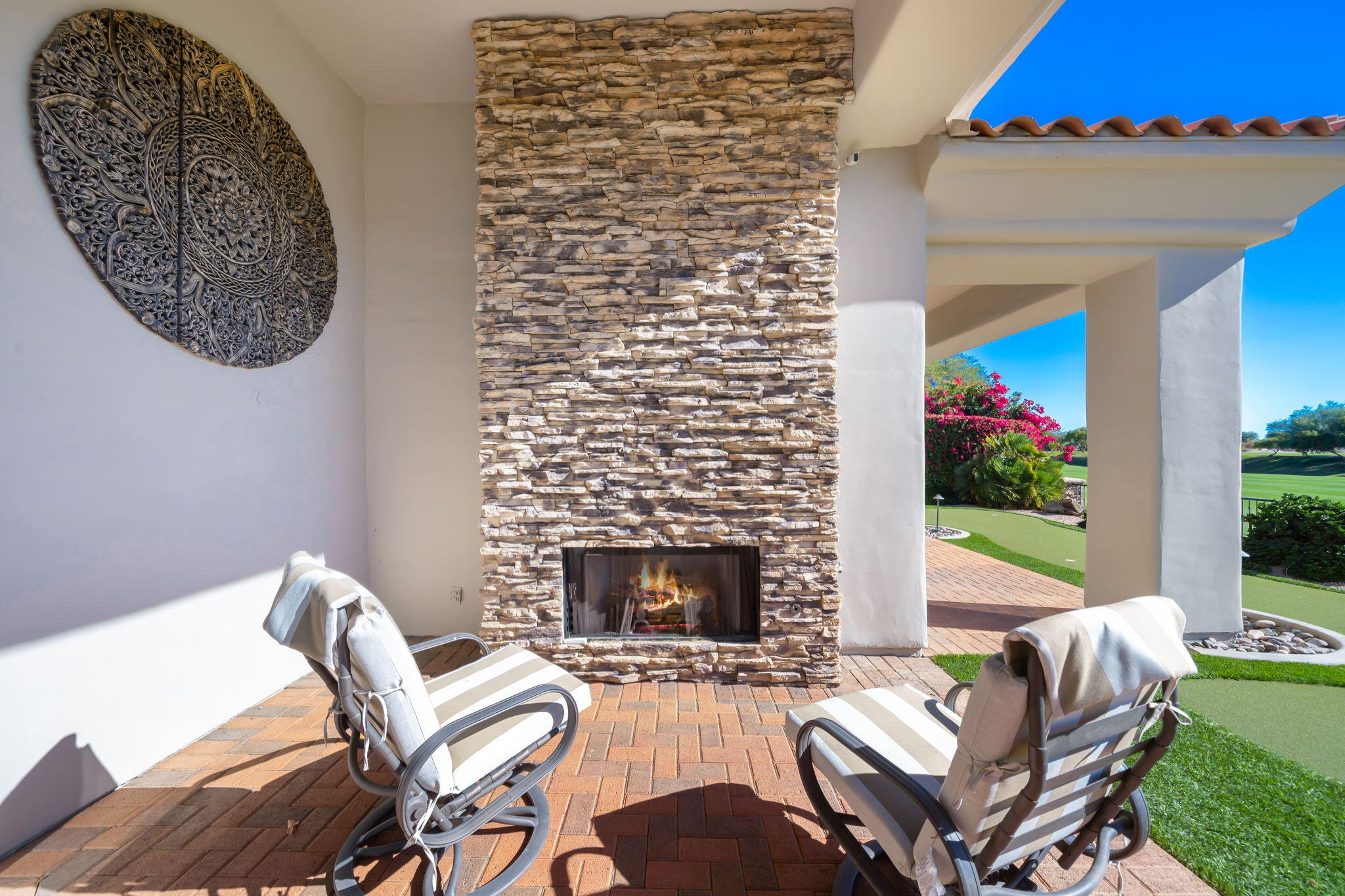290 Loch Lomond Road Rancho Mirage, CA 92270 - Photo 6 of 50 a living room with furniture a rug and a fireplace