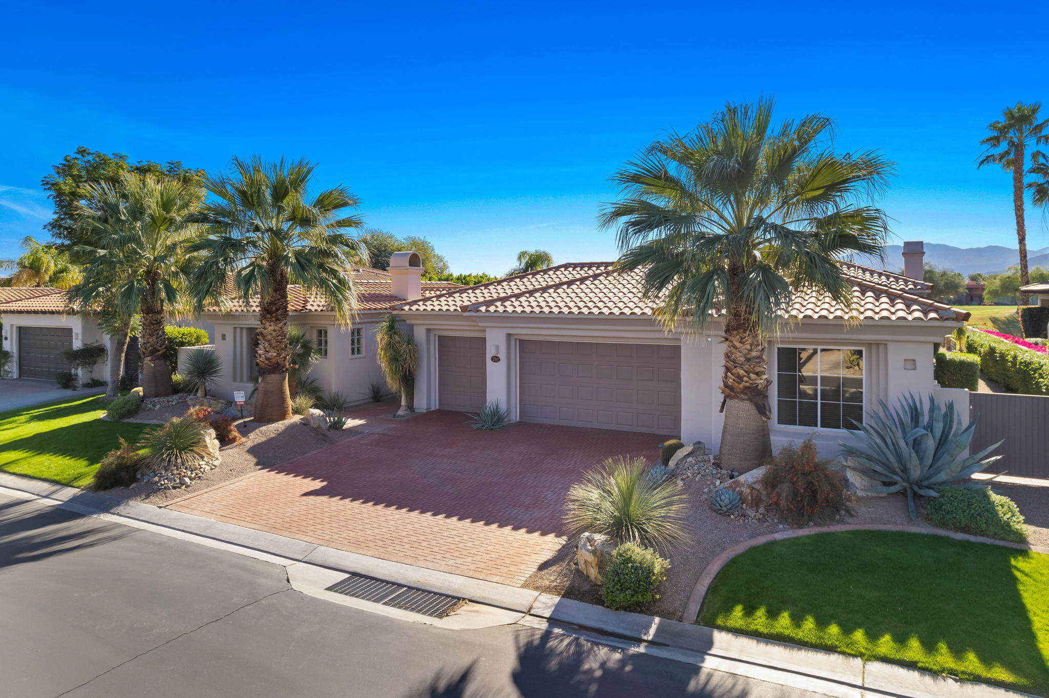 290 Loch Lomond Road Rancho Mirage, CA 92270 - Photo 7 of 50 a palm tree sitting in front of a house with a big yard