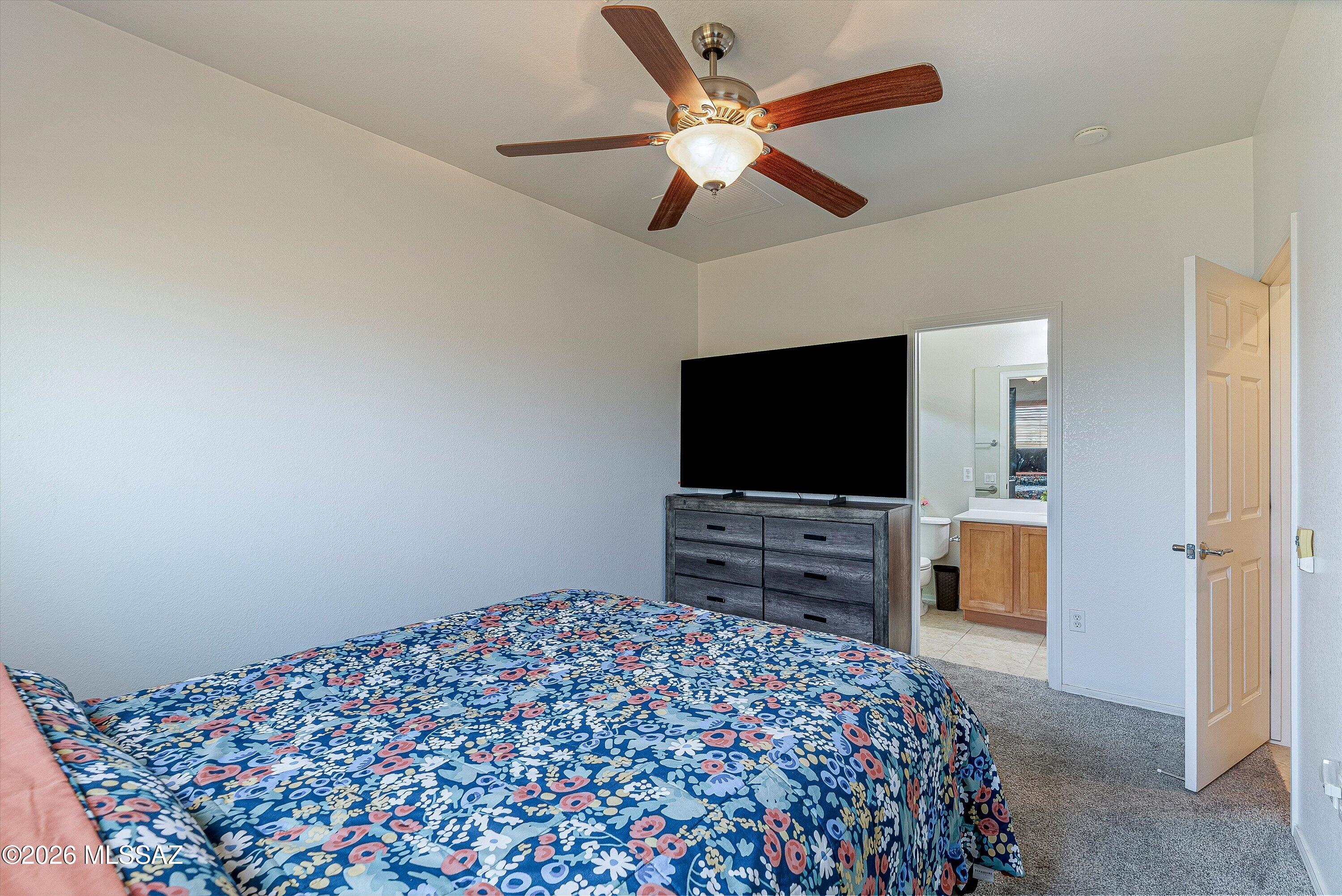 21163 East Treasure Road Red Rock, AZ 85145 - Photo 15 of 35 a bedroom with a bed and a flat screen tv