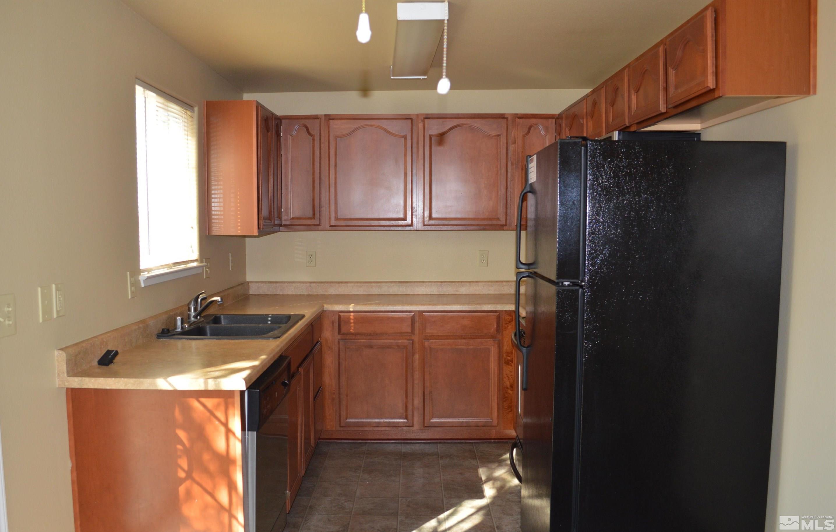1501 Gault Way Sparks, NV 89431 - Photo 3 of 17 a kitchen with a refrigerator and a sink
