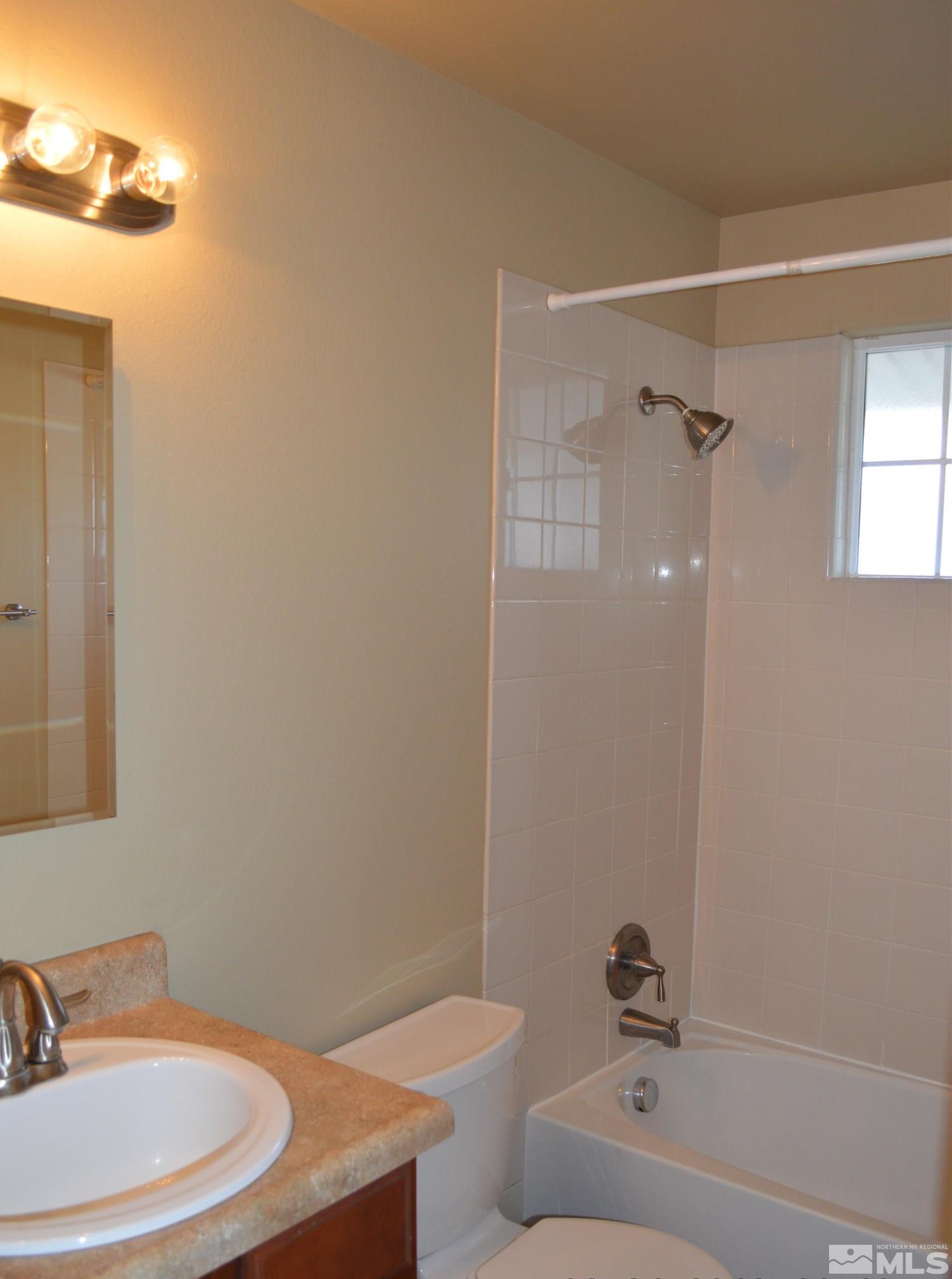 1501 Gault Way Sparks, NV 89431 - Photo 9 of 17 a bathroom with a sink a toilet and shower