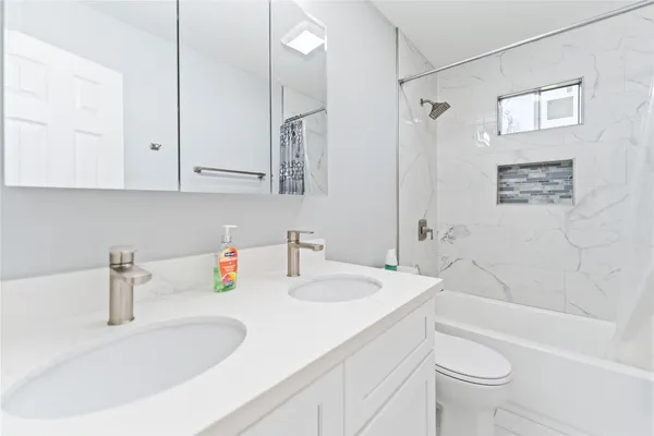 a bathroom with a sink a toilet and a bathtub