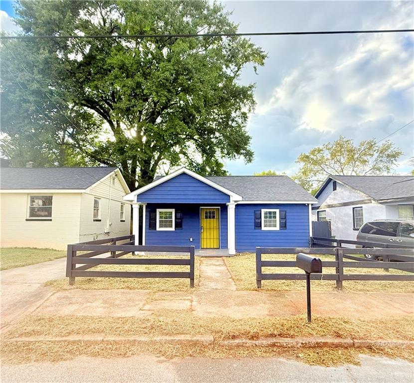 a front view of a house with a yard table and chairs