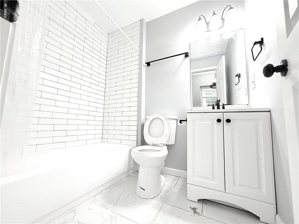 917 Garibaldi Street Southwest Atlanta, GA 30310 - Photo 3 of 9 a bathroom with a sink a toilet and shower