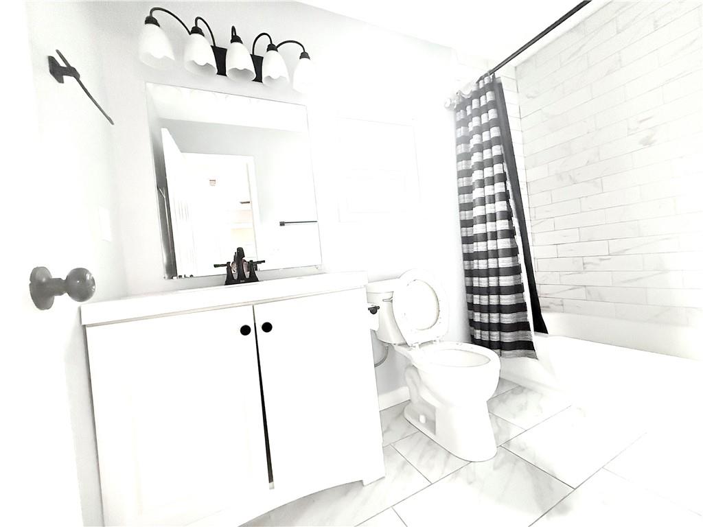 917 Garibaldi Street Southwest Atlanta, GA 30310 - Photo 4 of 9 a bathroom with a sink and mirror