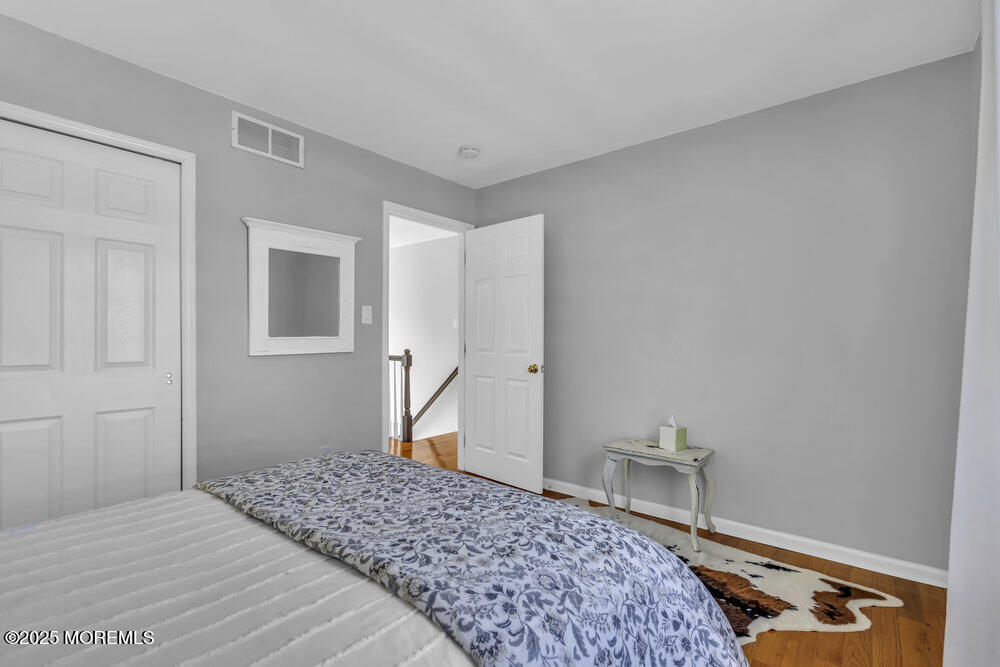 57 Gristmill Road Howell, NJ 07731 - Photo 50 of 80 a bedroom with a bed and a mirror