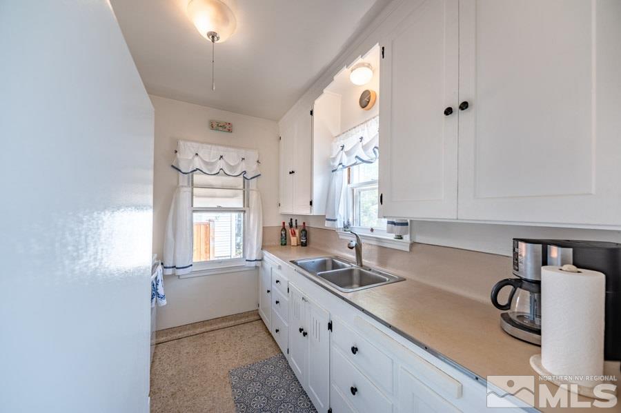 817 Gear Street Reno, NV 89503 - Photo 8 of 21 a kitchen with granite countertop a sink a window and cabinets