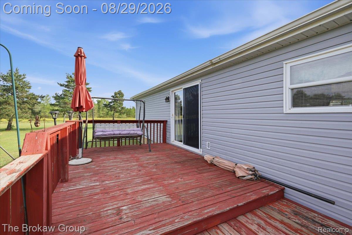 Exterior deck with a sliding glass door and a single-pane window