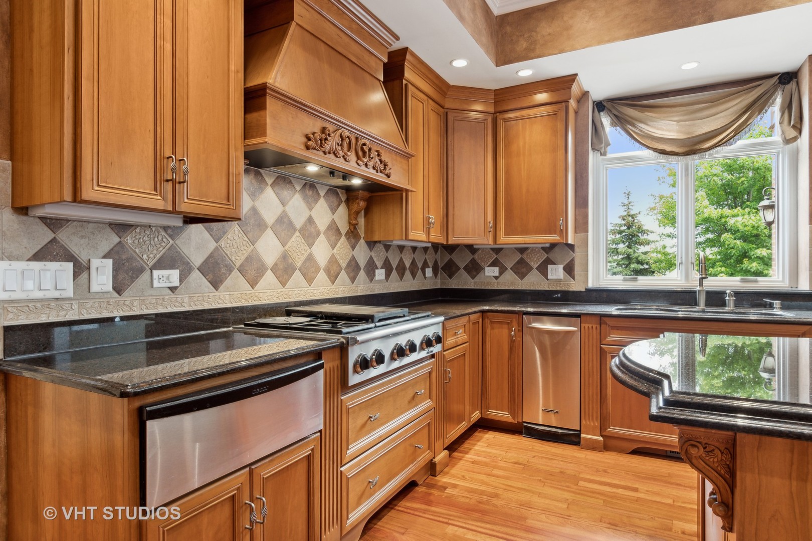 8S287 Hampton Circle Naperville, IL 60540 - Photo 7 of 42 a kitchen with stainless steel appliances granite countertop a stove a sink and a microwave