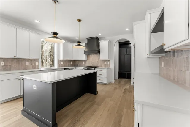 a kitchen with stainless steel appliances a refrigerator and cabinets