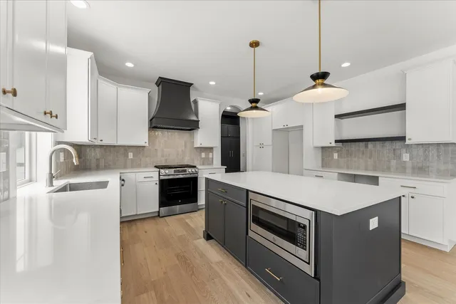 a kitchen with granite countertop white cabinets and white appliances