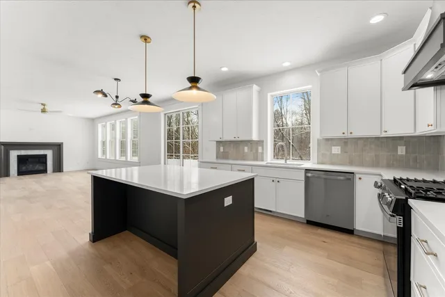a kitchen with a sink a stove and a wooden floor