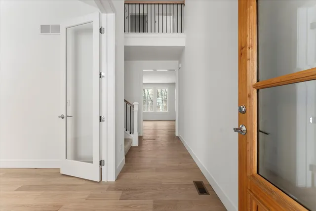 an empty room with a window and a ceiling fan