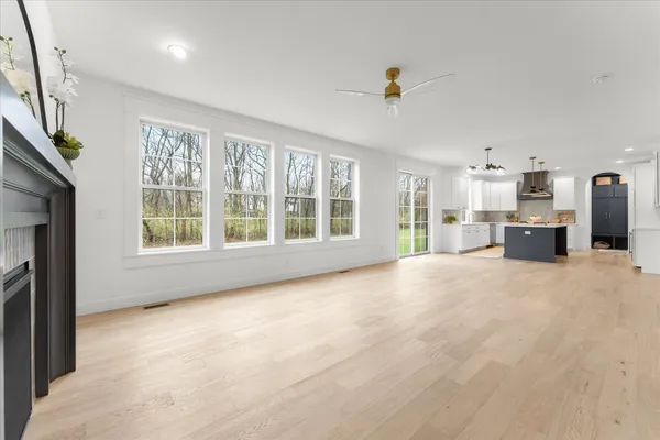 a large kitchen with stainless steel appliances kitchen island granite countertop a large counter top and a view of kitchen