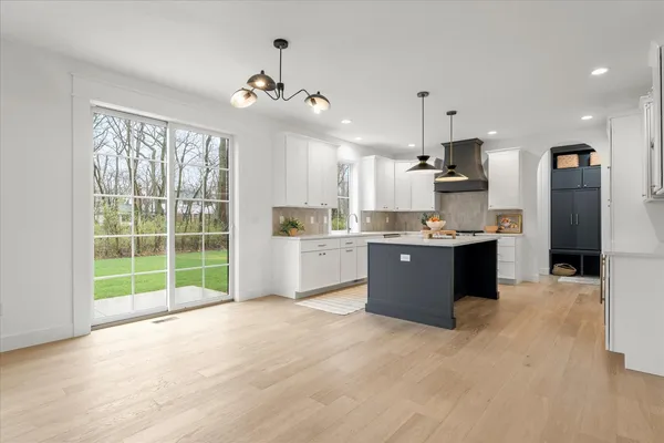a kitchen with a sink stove and cabinets