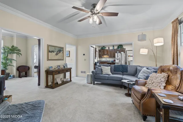 a kitchen with stainless steel appliances granite countertop a stove top oven a sink dishwasher a dining table and chairs with wooden floor