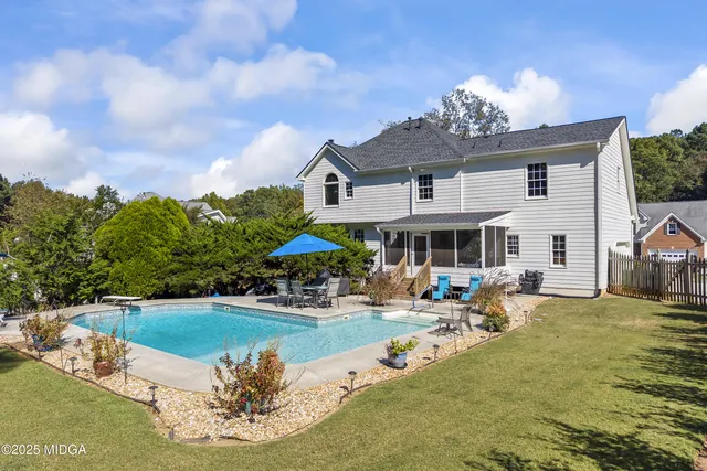 a view of a house with a yard and pathway
