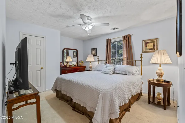 a living room with furniture pool table and a flat screen tv
