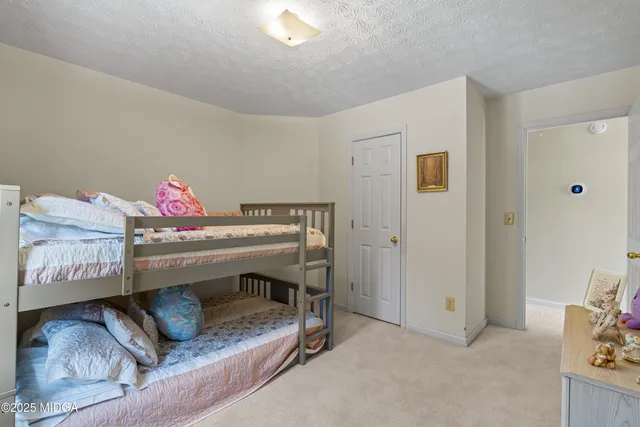a room with lots of white furniture and plants