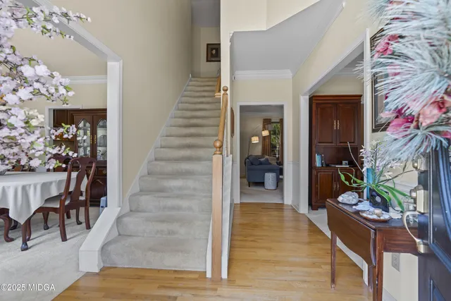 a living room with furniture potted plant and a chandelier