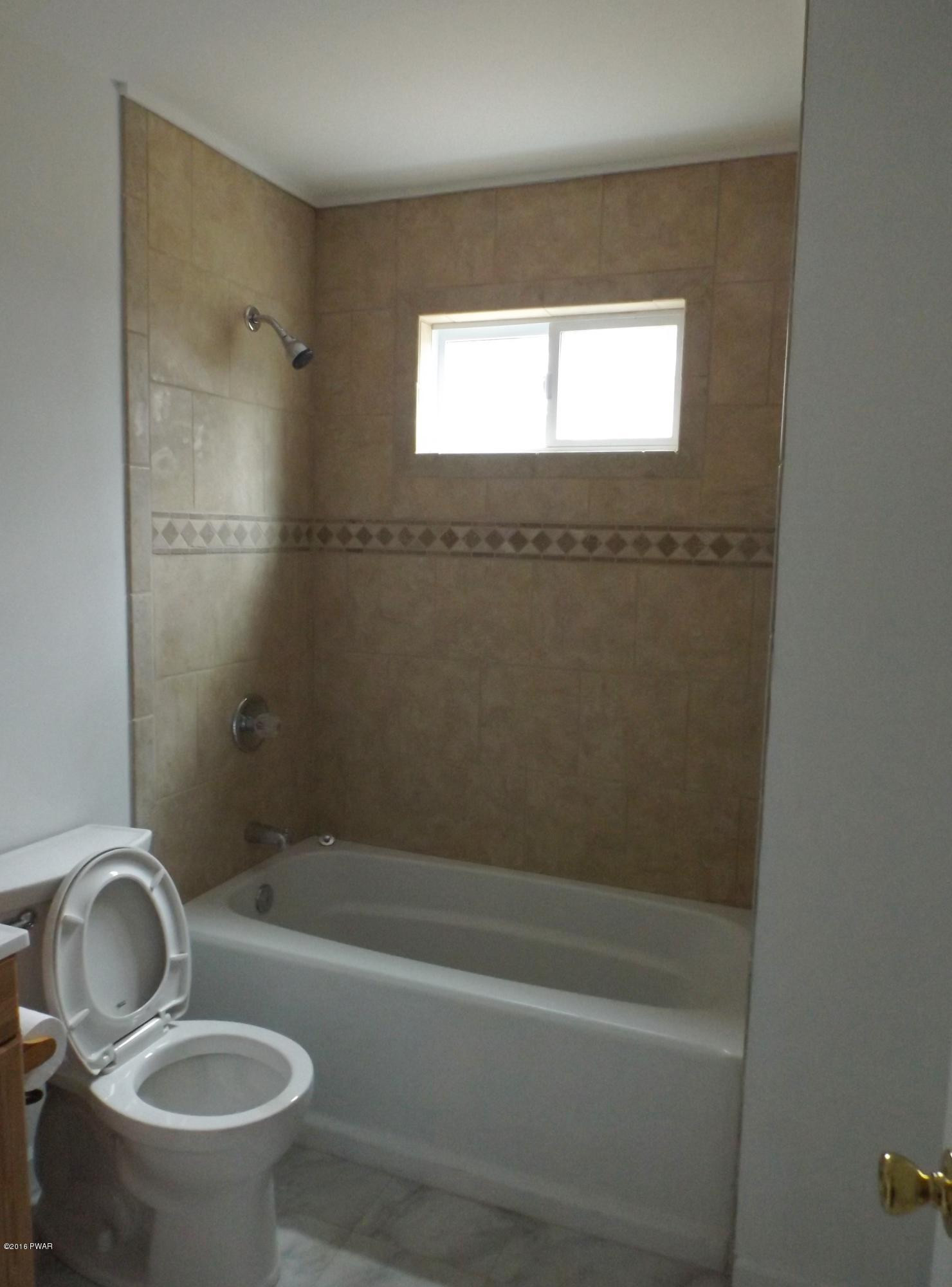 109 Keystone Court Dingmans Ferry, PA 18328 - Photo 7 of 18 a bathroom with a sink toilet and shower