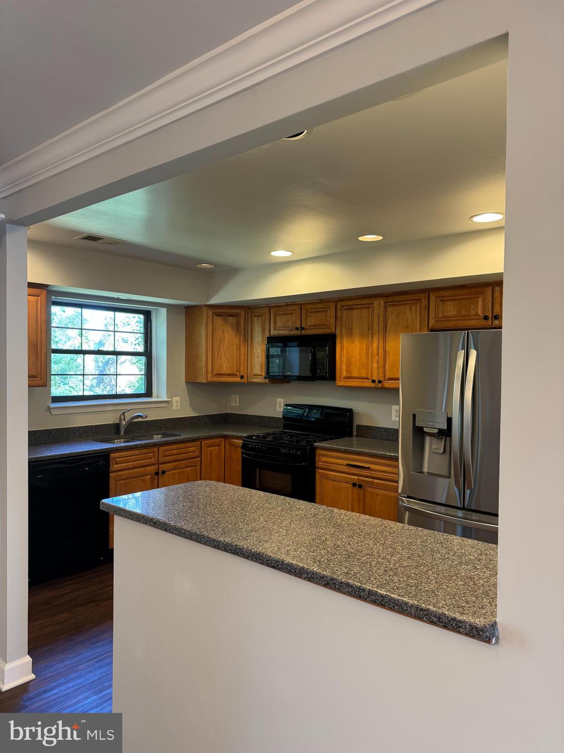 26 Alanbrooke Court, Unit C Towson, MD 21204 - Photo 2 of 9 a kitchen with stainless steel appliances granite countertop a sink and a stove