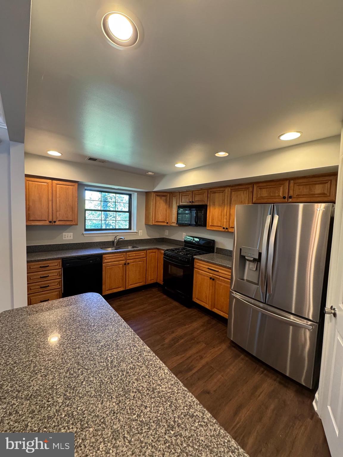 26 Alanbrooke Court, Unit C Towson, MD 21204 - Photo 3 of 9 a kitchen with stainless steel appliances granite countertop a refrigerator and a sink