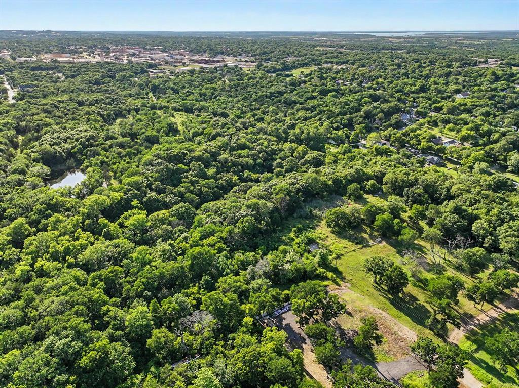 830 East Morgan Street Denison, TX 75021 - Photo 2 of 8 an aerial view of a houses with a lush green hillside