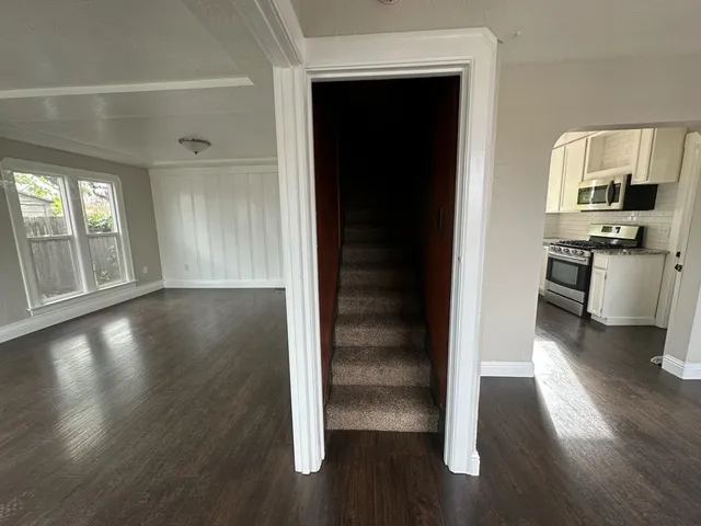 a view of a kitchen with wooden floor and a kitchen