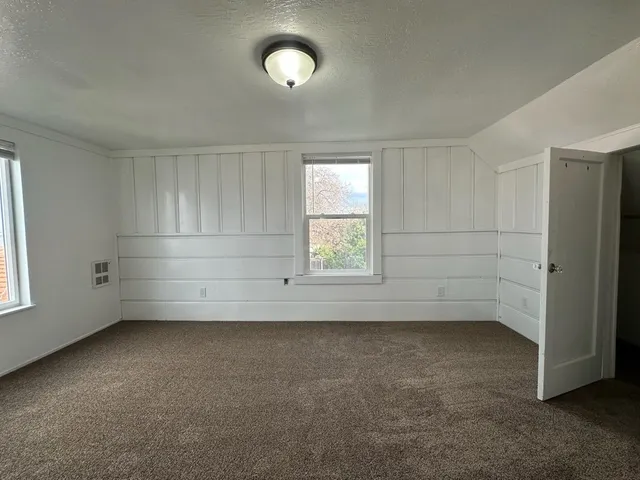 an empty room with a empty space and windows
