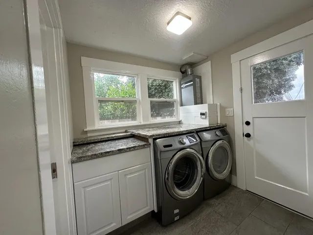 a utility room with sink dryer and washer