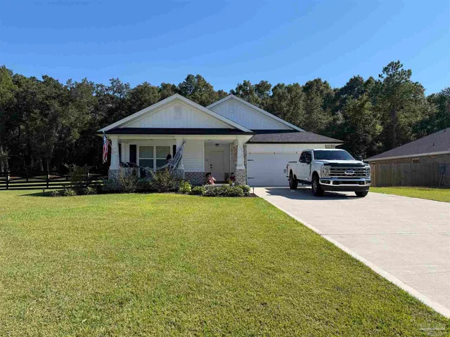 a car parked in front of a house with yard