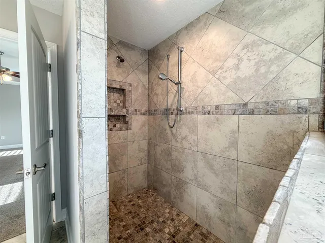 a bathroom with a bath tub sitting next to a window