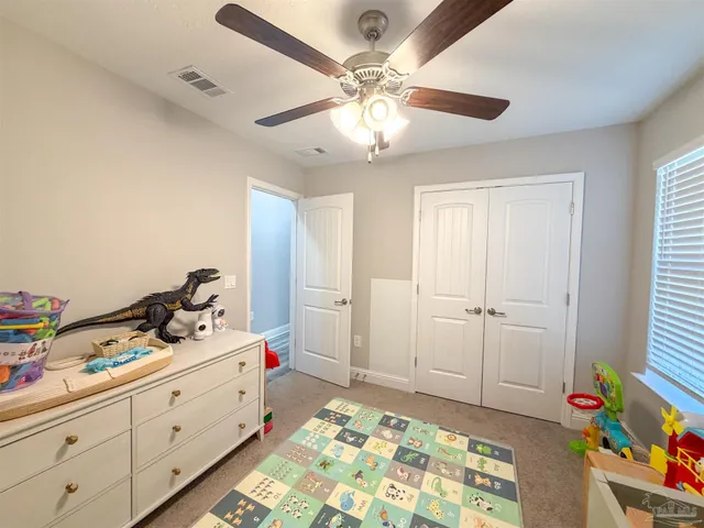 a bedroom with bed and window