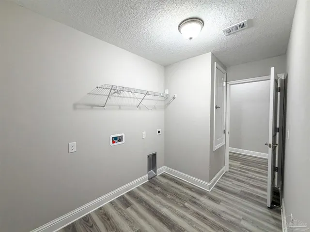 a view of a room with wooden floor fan and window
