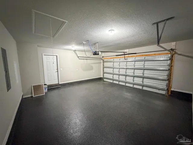 a view of empty room with wooden floor and fence