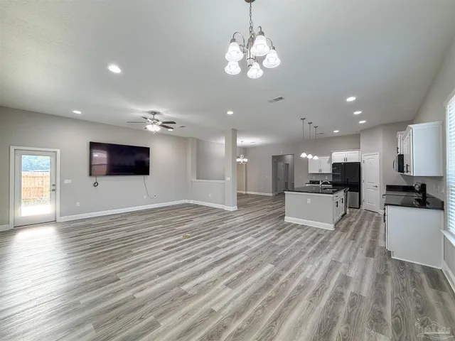 a view of kitchen with cabinets stainless steel appliances with wooden floor