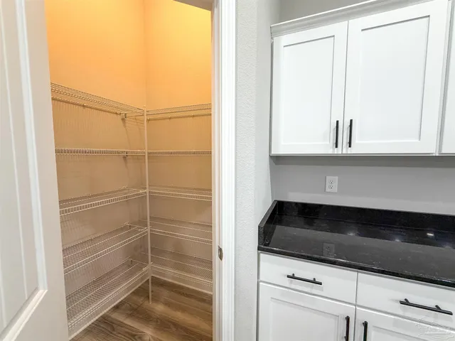 a kitchen with stainless steel appliances granite countertop a stove a refrigerator and a microwave