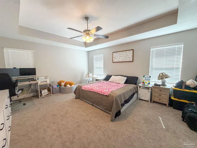 a spacious bedroom with a bed and a couch